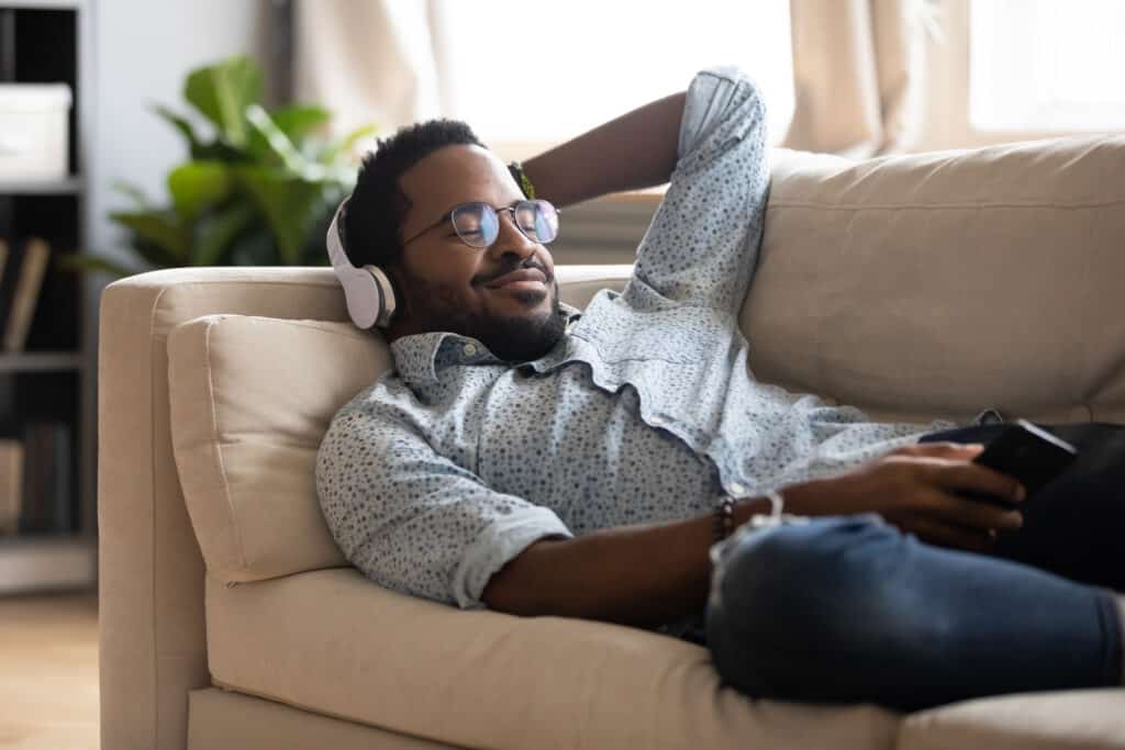 Carefree young man listening to favorite classic music.