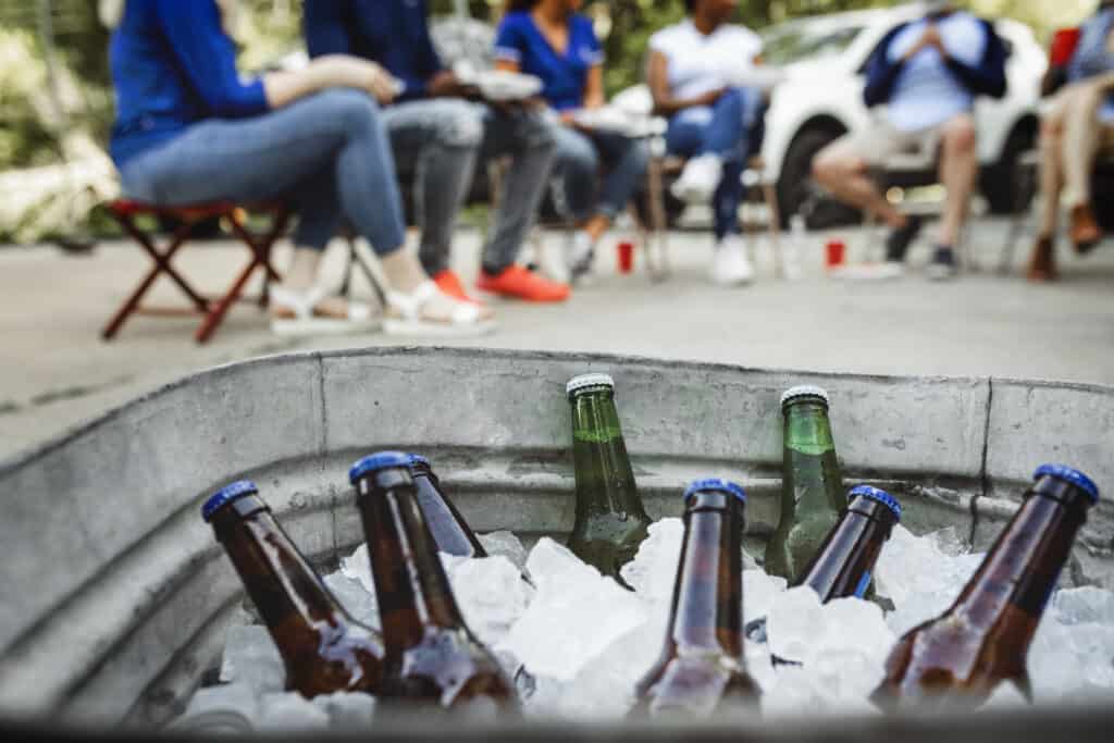 Cold beers in a bucket of ice Glass bottles in metal ice bucket