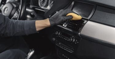 Person cleaning car dashboard