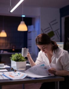 image of woman working and drinking from cup