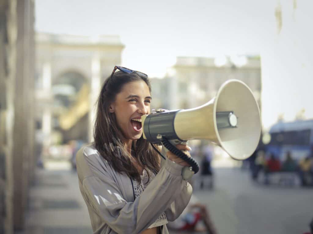 pexels-andrea-piacquadio-3761509 woman talking into bullhorn