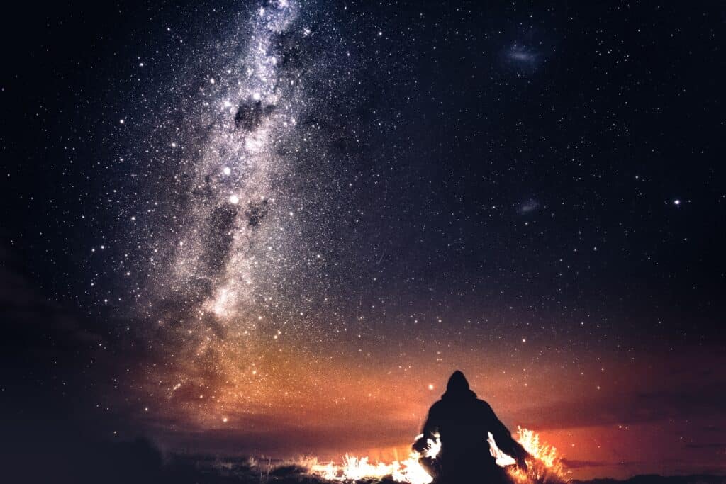 man sitting under the stars