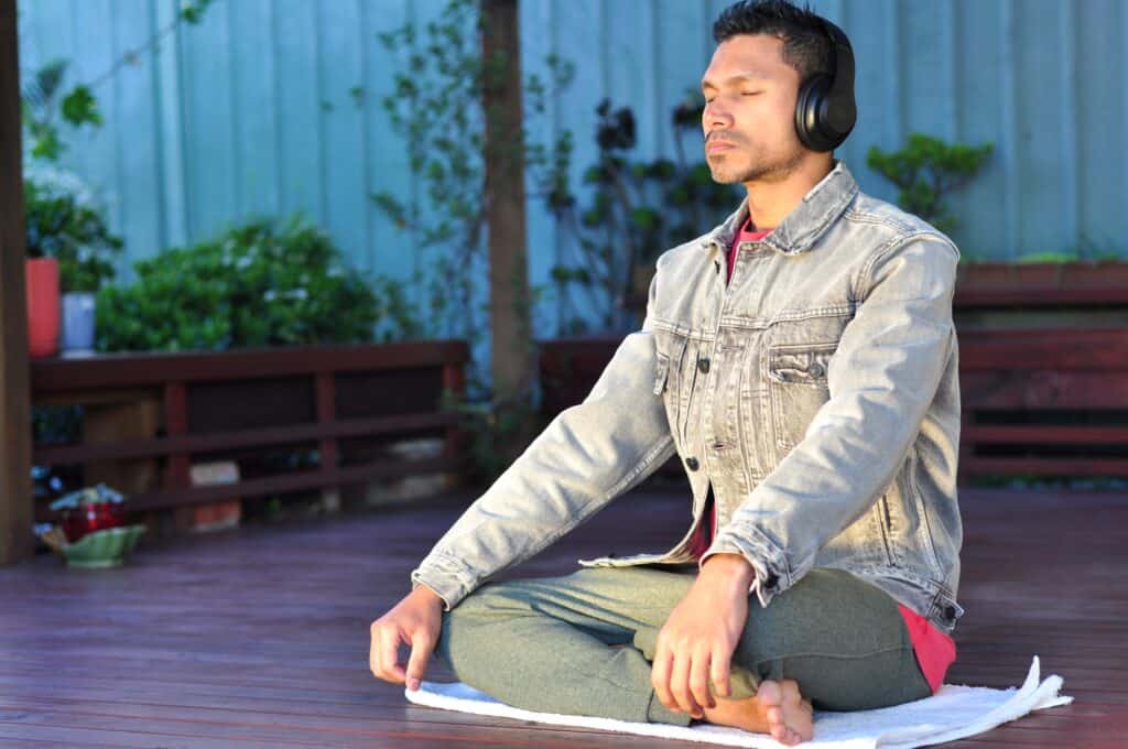 Man meditating with headphones