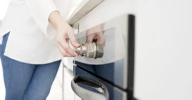 woman using control panel on dishwasher